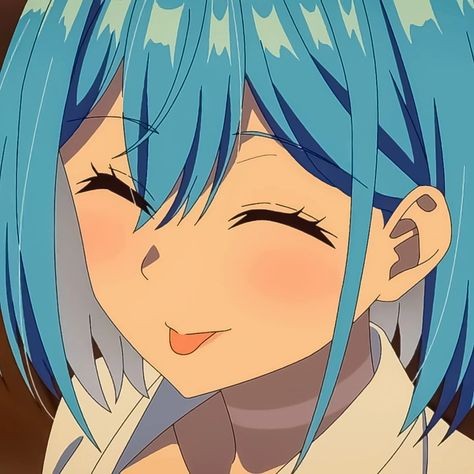 Cindara, smiling with short blue hair